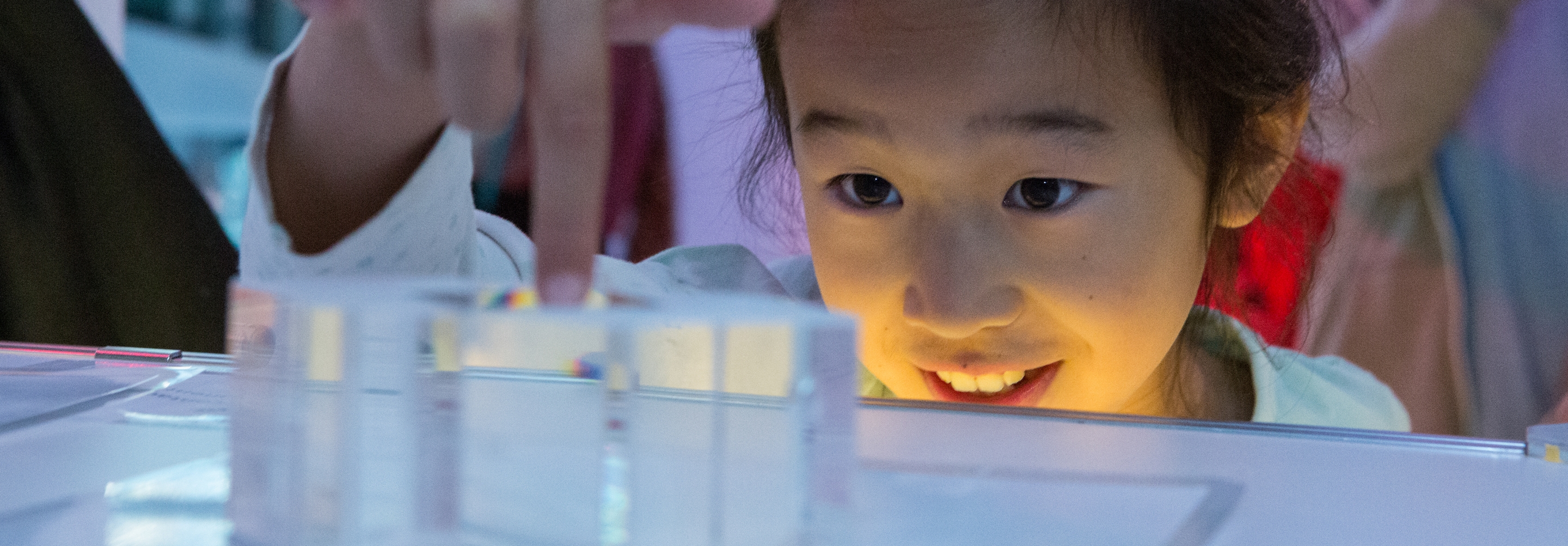 little girl making an experiment with wonder in her eyer at brainstem festival at Perimeter Institute